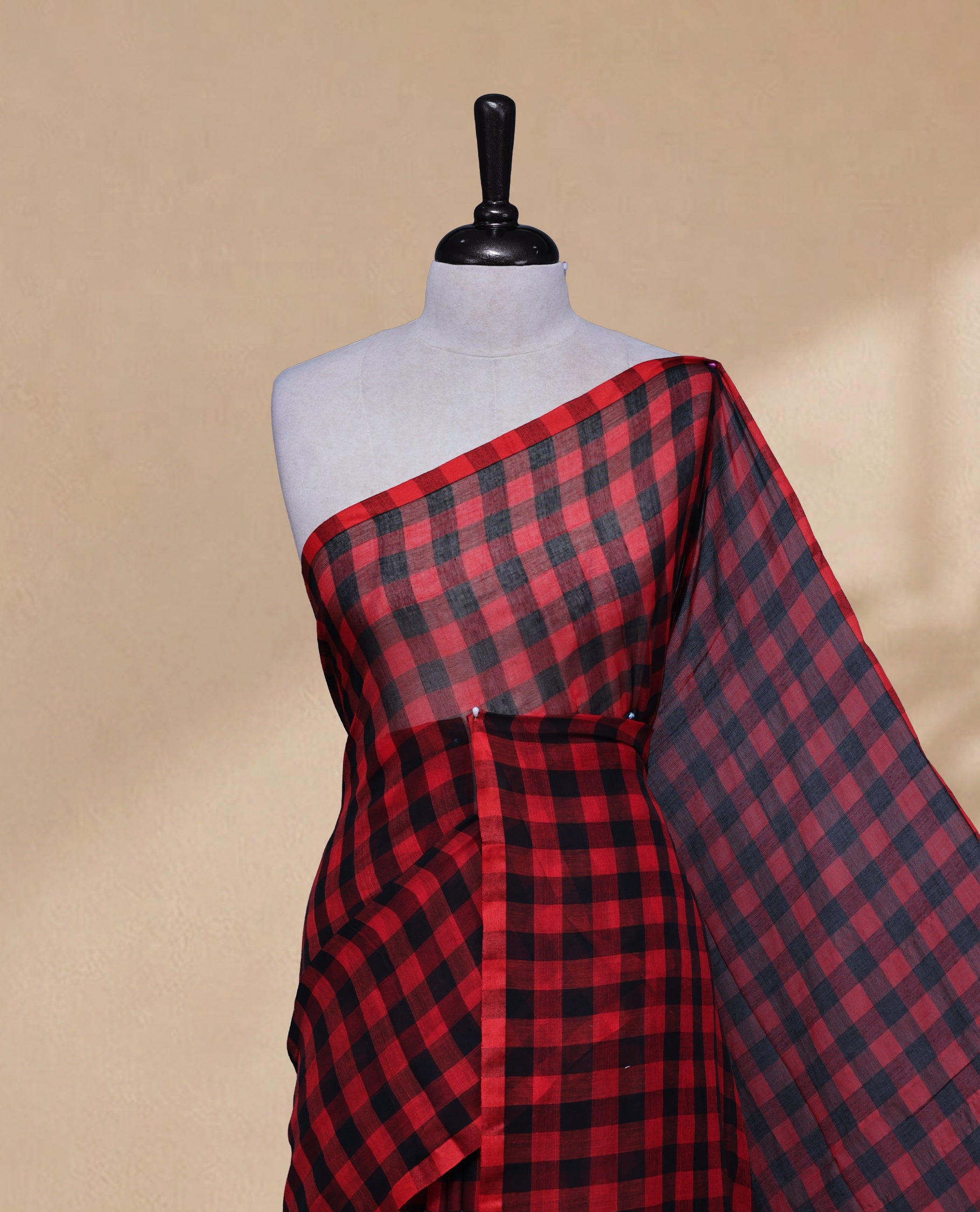 Red & Black colour Khadi Mul cotton saree featuring Check Pattern on body,Enhanced Minimalist Borderless Finish & elegant Tassels at pallu.