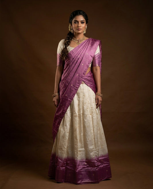 Off White colour half saree material featuring delicate zari buttas on the blouse and skirt, paired with a contrast Pink zari border and matching small zari motifs dupatta
