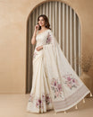 Cream colour organza saree featuring floral digital print with sequins With thread buttas on print, complemented by simple gold kasavu kara & elegant tassels on pallu.