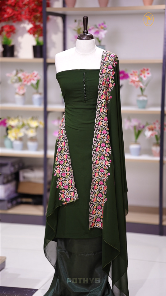 Green colour Chiffon churidhar material featuring a plain top adorned with delicate beads work on the neckline, paired with a plain bottom, Highlighted by a dupatta with floral embroidery, sequins, and scalloped edges.