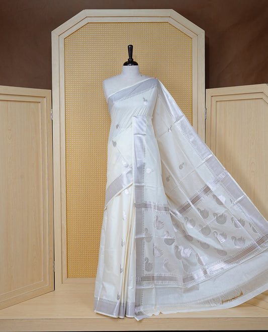 Cream Cotton Kerala Saree with Rose Gold Zari Duck Motifs, Rose Gold Zari Duck Pattern Border and  Pallu, Paired with a Matching Blouse Piece.