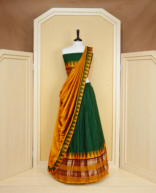 Green colour Semi Stitched Dhavni set Featuring Green Skirt With Contrast Mustard colour with Zari border, paired with UnStitched Blouse & Elegant Dupatta.