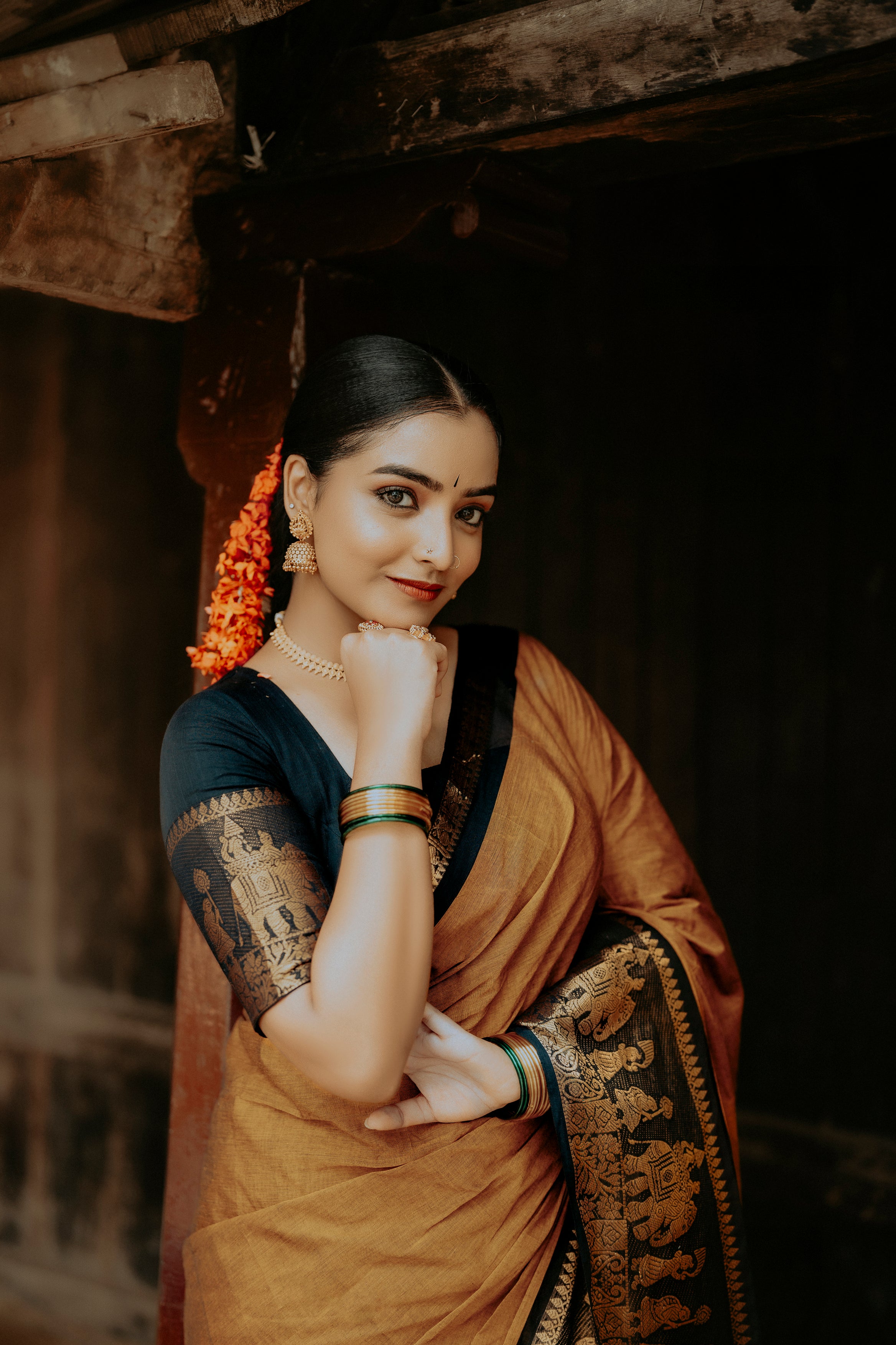 Mustard colour chettinad cotton saree with Elegant plain body, complemented by Contrast Black colour with Gold zari  border, paired with matching blouse piece.