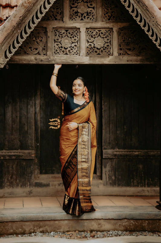 Mustard colour chettinad cotton saree with Elegant plain body, complemented by Contrast Black colour with Gold zari  border, paired with matching blouse piece.