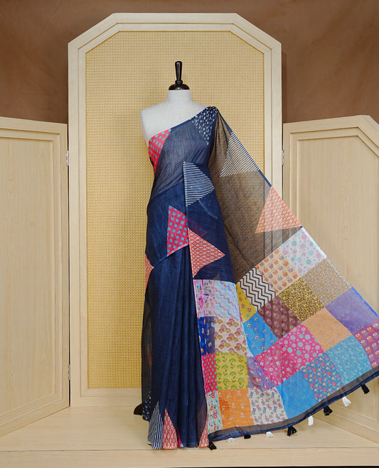 Black colour Semi Linen Saree Featuring Elegant Plain body with Colourful Triangle Border, Unique Tassel Detailing For Festive Vibe, Patch worked Blouse piece.