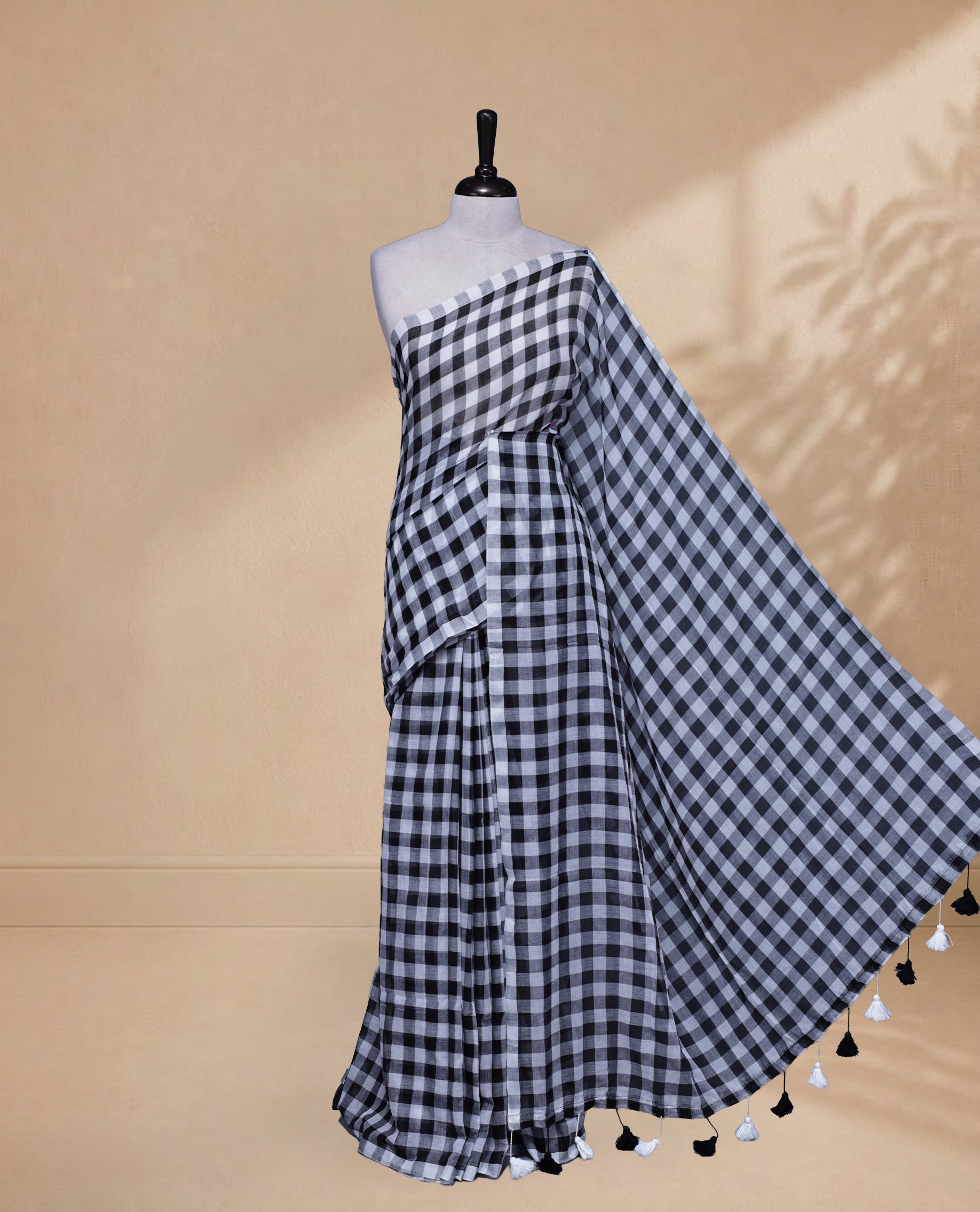Black & White colour Khadi Mul cotton saree featuring Check Pattern on body,Enhanced Minimalist Borderless Finish & elegant Tassels at pallu.
