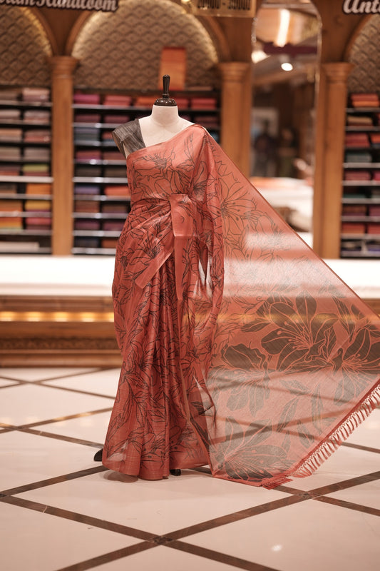 Red & Black colour Semi linen tissue saree featuring full digital floral prints across the body, The saree is highlighted with a contrast floral printed pallu and comes with a plain contrasting blouse piece.