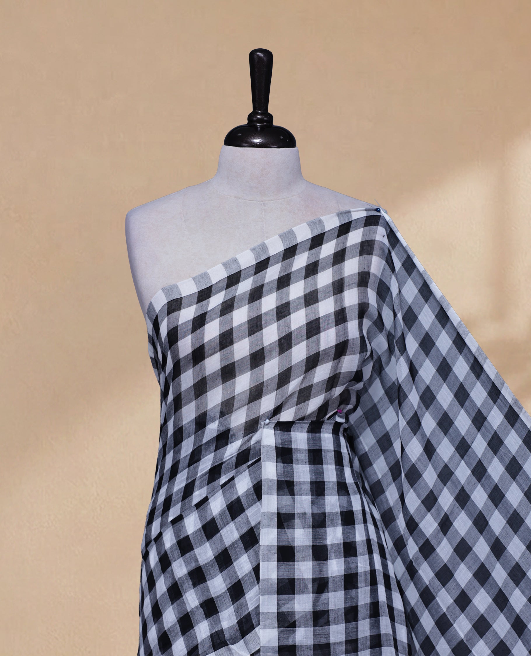 Black & White colour Khadi Mul cotton saree featuring Check Pattern on body,Enhanced Minimalist Borderless Finish & elegant Tassels at pallu.