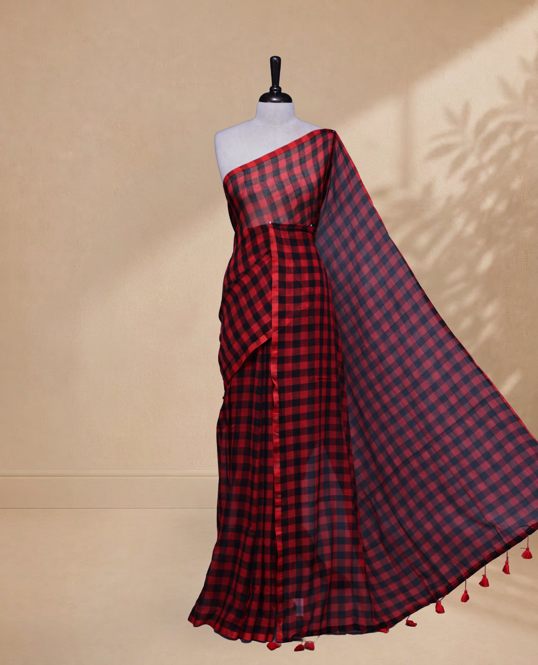 Red & Black colour Khadi Mul cotton saree featuring Check Pattern on body,Enhanced Minimalist Borderless Finish & elegant Tassels at pallu.