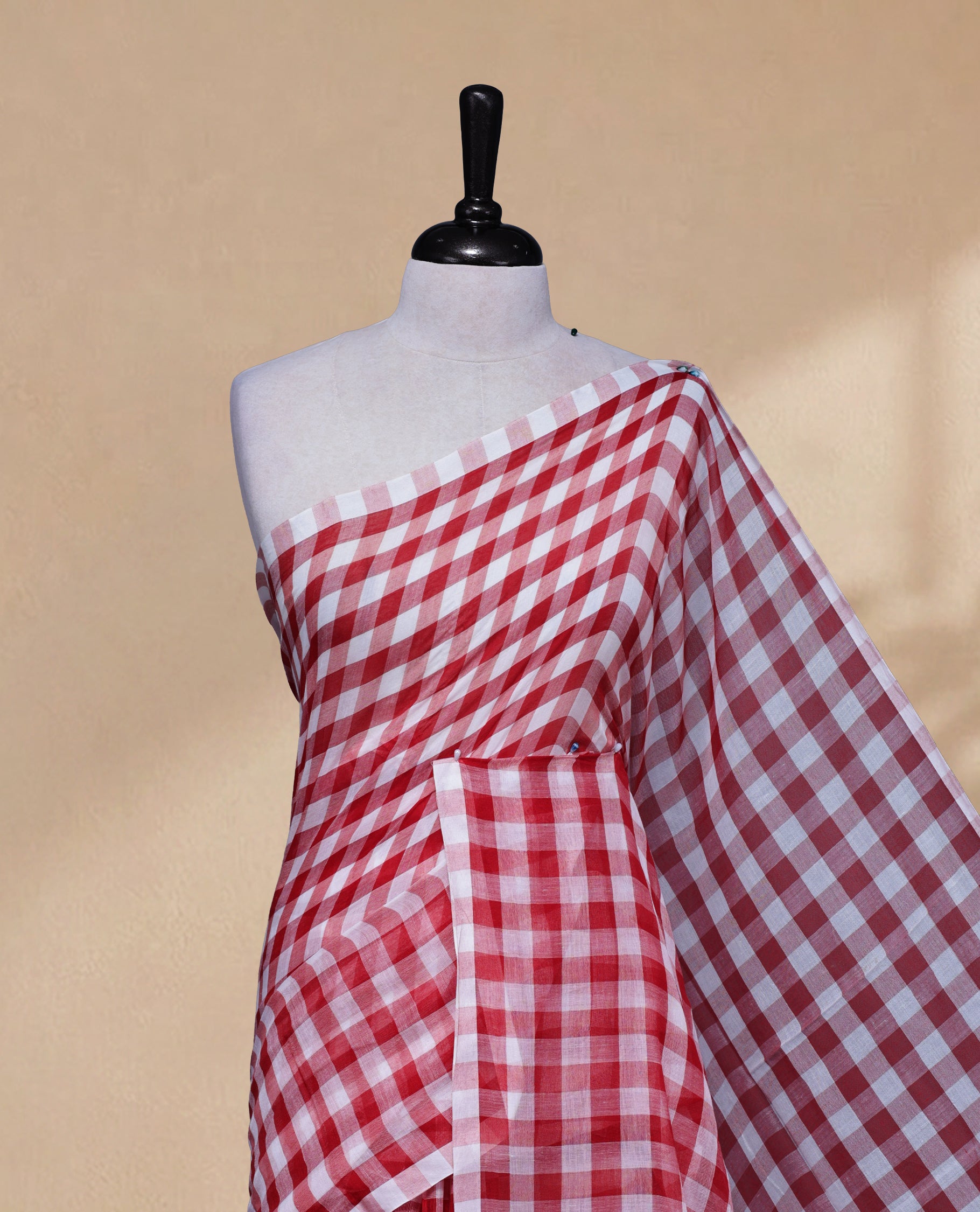 Red & White colour Khadi Mul cotton saree featuring Check Pattern on body,Enhanced Minimalist Borderless Finish & elegant Tassels at pallu.
