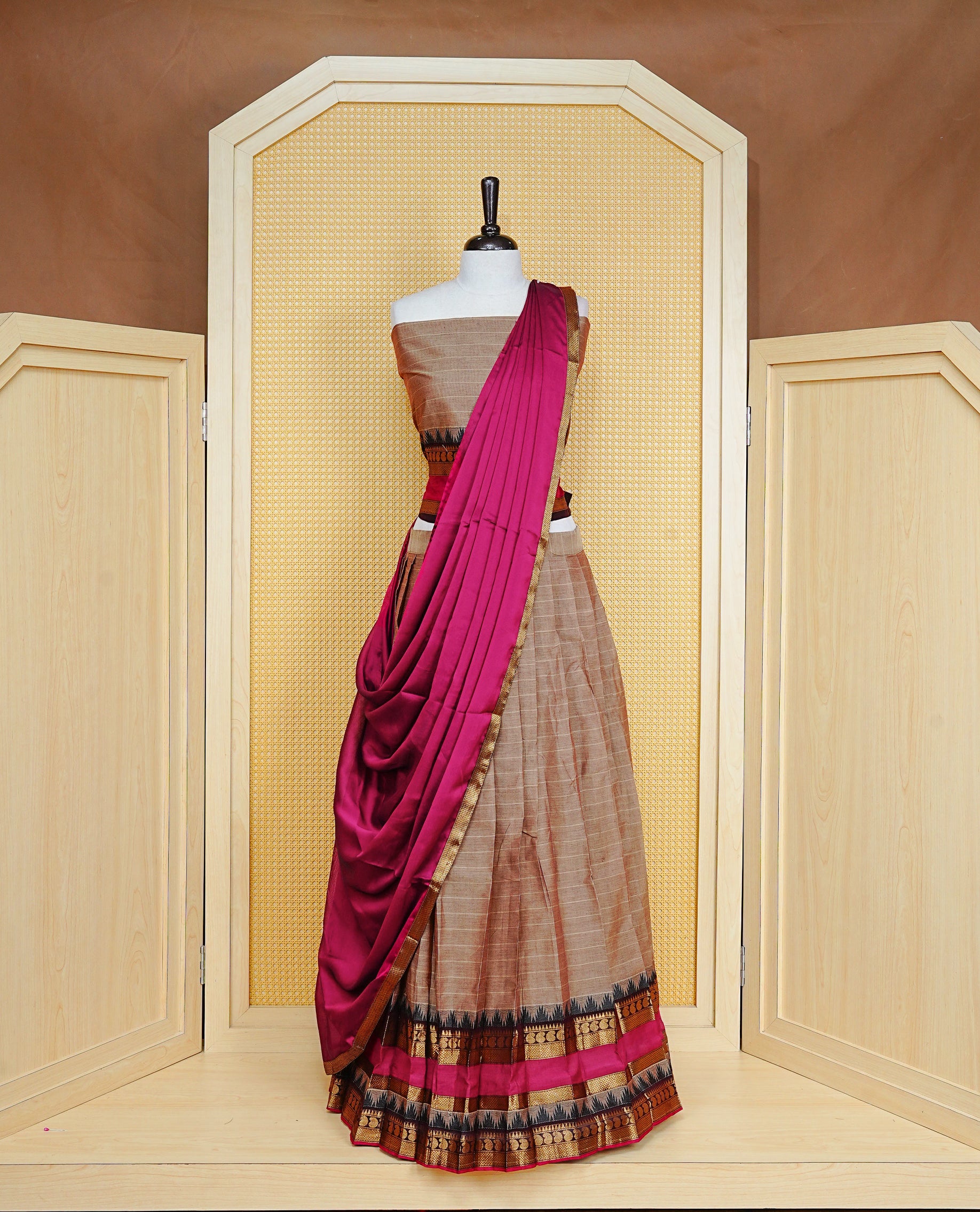 Beige colour Semi Stitched Dhavni set Featuring Beige Skirt With Contrast Black & Magenta colour with Zari border, paired with UnStitched Blouse & Elegant Dupatta.