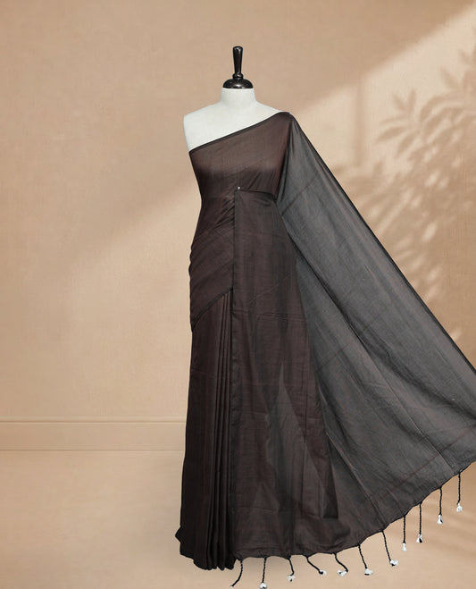 Chocolate Colour Mul Cotton saree featuring Elegant plain body, Comes with no border, finished with stylish tassels.