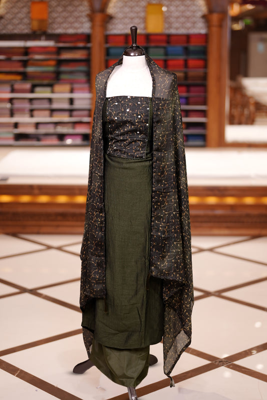 Green colour semi silk salwar material featuring subtle mirror work on the top, paired with a plain matching bottom & The set is completed with chiffon dupatta adorned with golden abstract prints for a classy finish.
