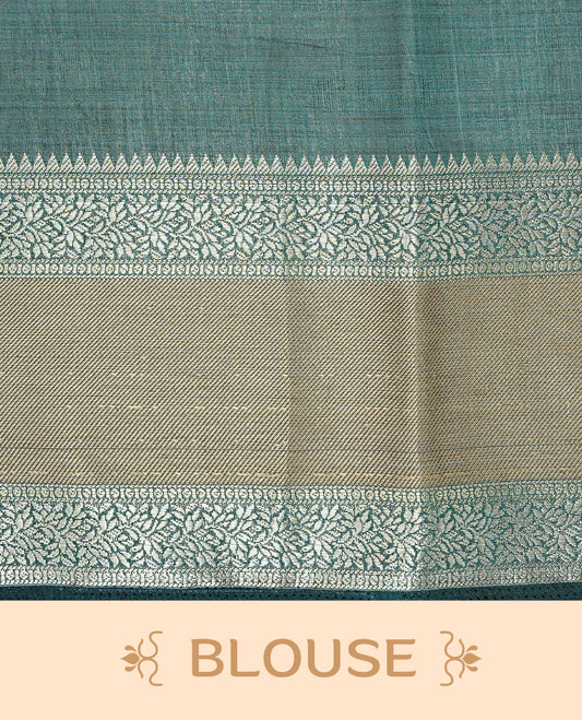 Cream colour semi Tussar silk saree featuring  Elegant body, Complemented by contrast Bottle Green with rich zari detailed for onam special, paired with contrast Blouse for Festive look.