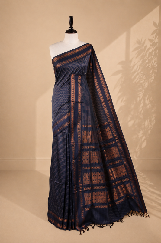Grey colour kalyani cotton saree featuring gold zari check pattern on body, complemented by self colour with Antique zari border, paired with matching blouse piece.