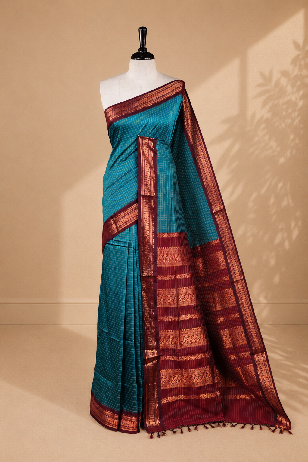 Blue colour kalyani cotton saree featuring antique zari motifs on body, complemented by Maroon colour with Antique zari border, paired with matching blouse piece.