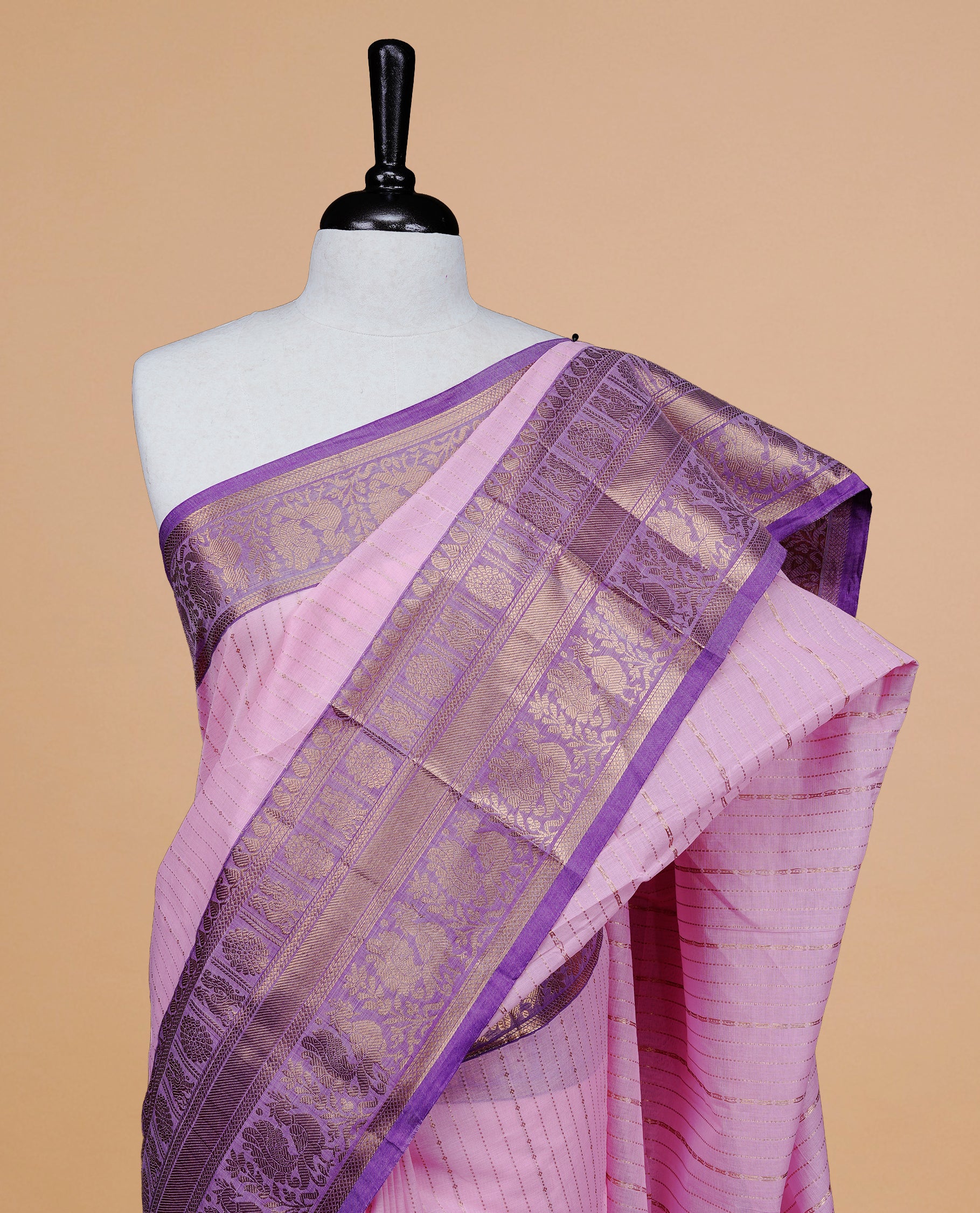 Pink colour chettinad cotton saree featuring  gold zari stripes on body, complemented by Purple border, paired with matching blouse piece.
