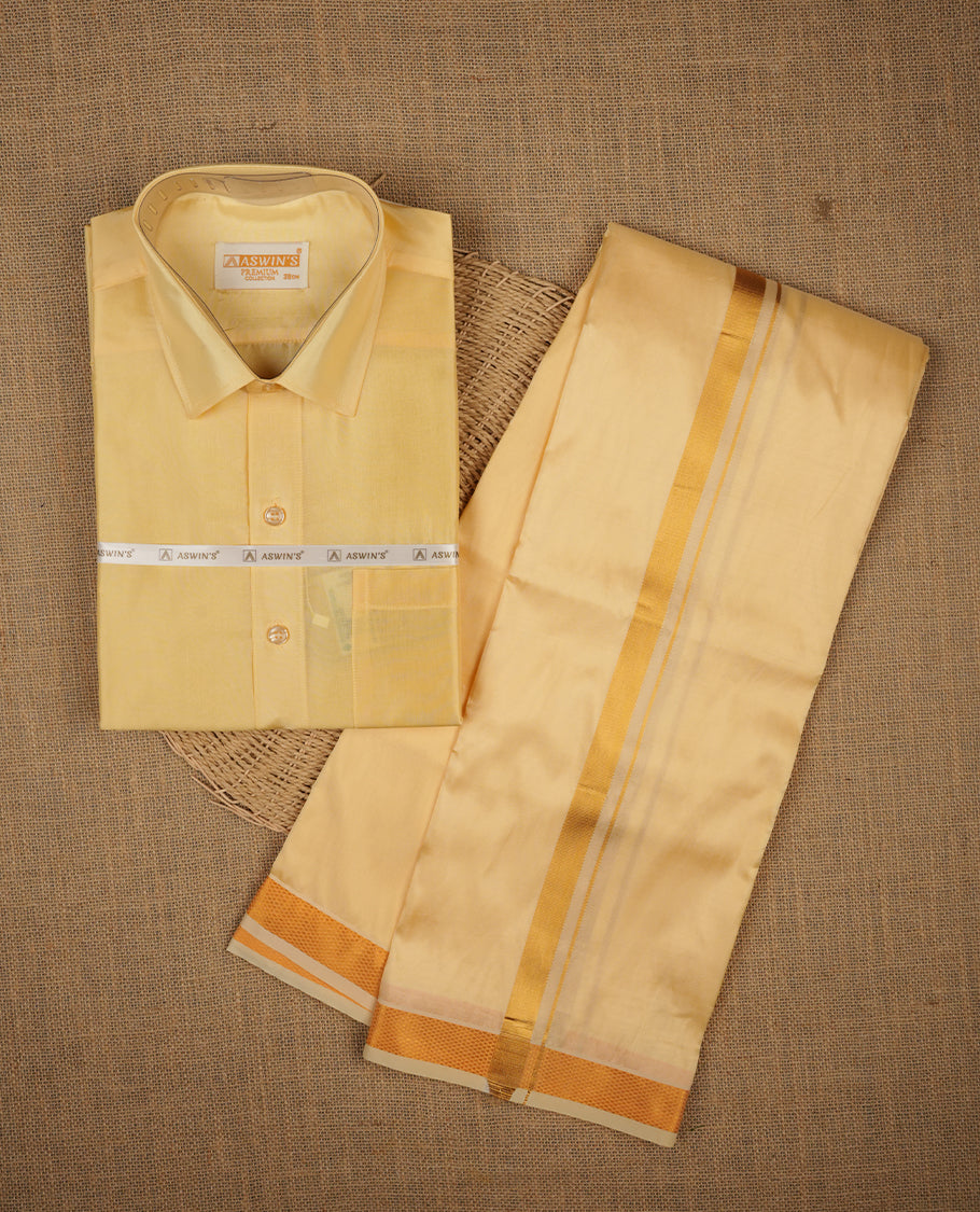 Biscuit colour shirt and dhoti with gold colour border, paired with matching colour silk saree featuring gold zari buttas and traditional border paired with matching blouse piece.