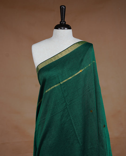 Peacock Green colour Mul Cotton saree featuring a plain body with sequin detailing, highlighted by a small gold colour border, without blouse piece.