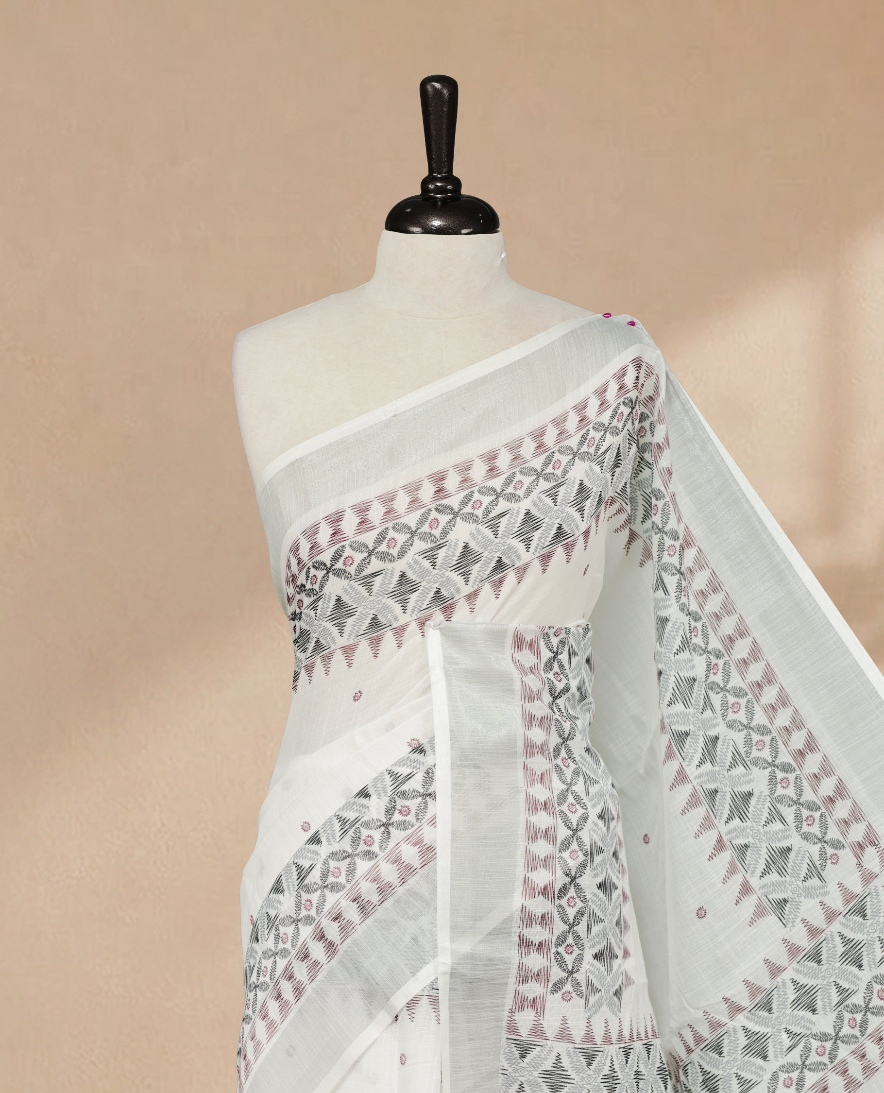 White Colour Semi Linen colour saree featuring Thread buttas on body & border, paired with matching blouse piece thread worked border.
