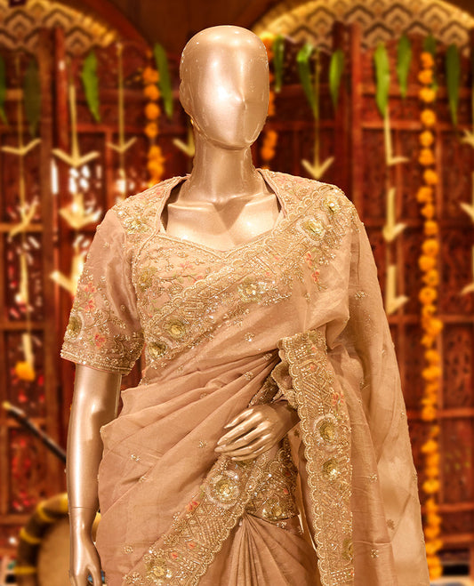 Pastel onion colour tissue organza designer saree featuring delicate embroidery and beadwork across the body, finished with heavy embellished border and pallu, paired with a matching tissue organza designer readymade blouse.
