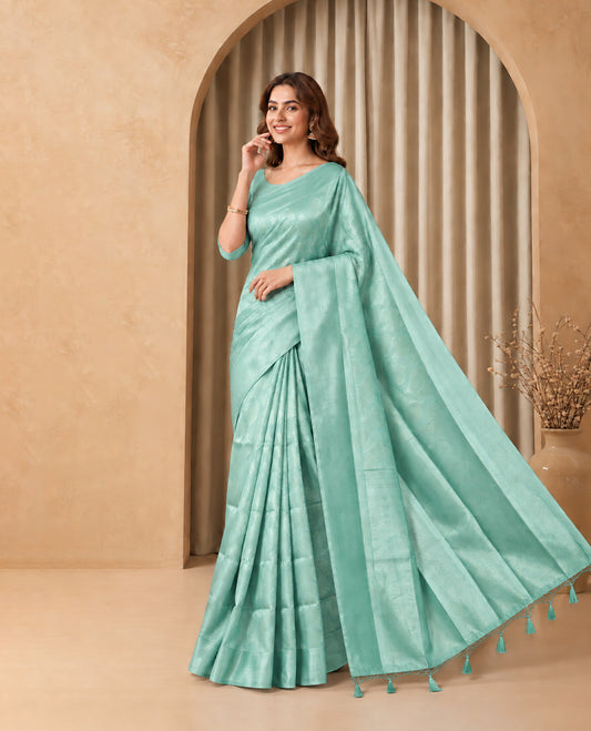 Light Pista Green Colour Elite Soft Silk Saree with silver zari leaf motifs on the body, a self Banarasi silver zari border and brocade pallu, Paired with a blouse Piece featuring small silver zari buttas.