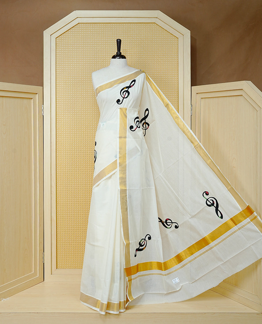 Cream Colour Kerala Saree Featuring Black Instrument Motifs And A Classic Gold Zari Border, Paired With A Matching Blouse Piece.