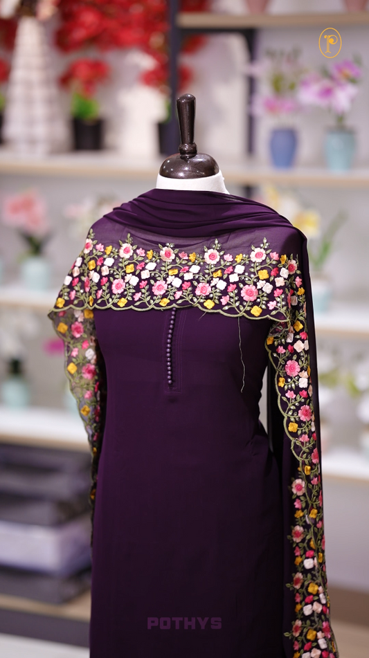 Wine colour Chiffon churidhar material featuring a plain top adorned with delicate beads work on the neckline, paired with a plain bottom, Highlighted by a dupatta with floral embroidery, sequins, and scalloped edges.